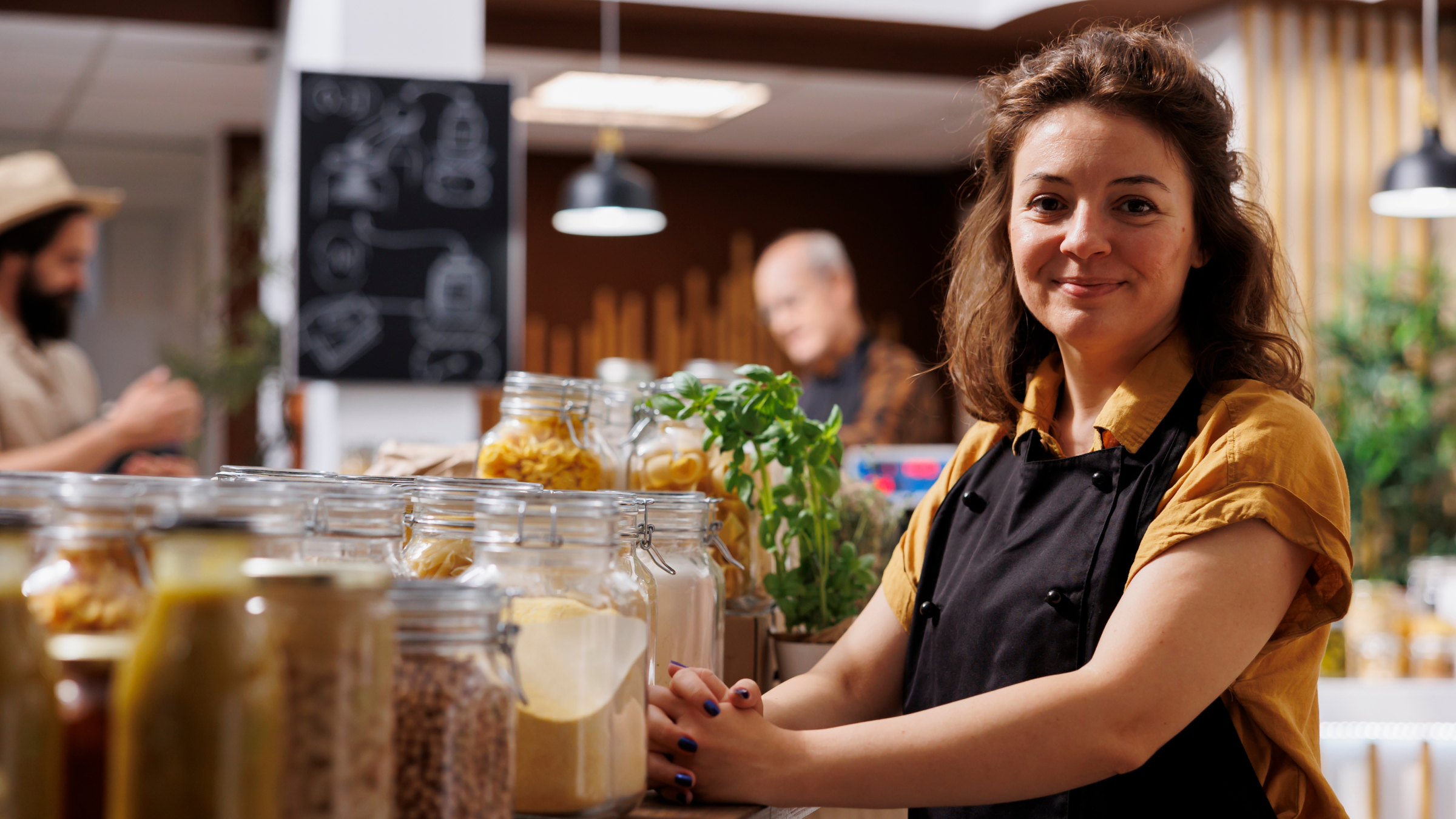 Woman standing in a shop, representing a self-employed worker preparing to submit her first digital tax return under MTD.