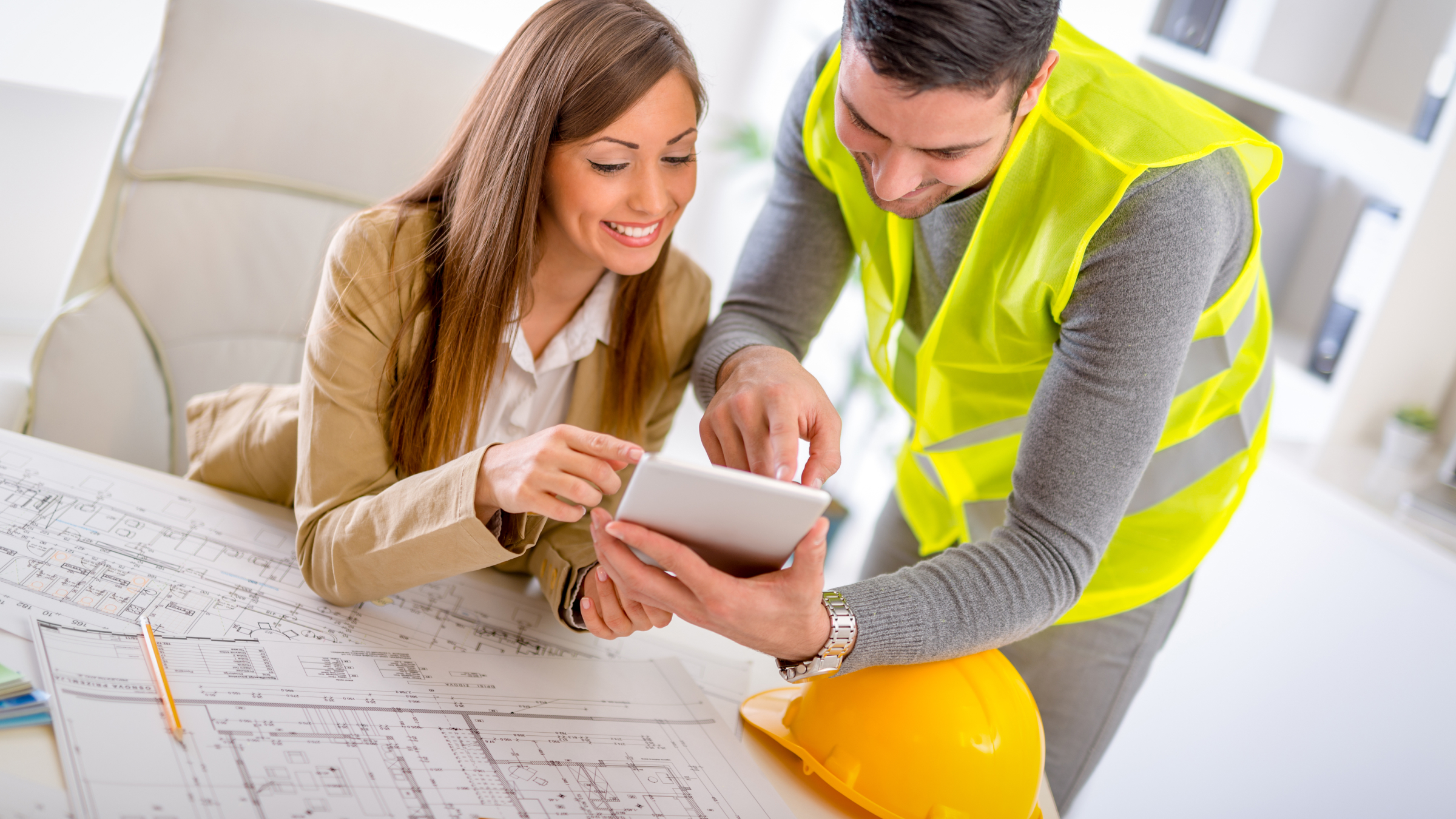 Construction worker and colleague reviewing CIS refund details