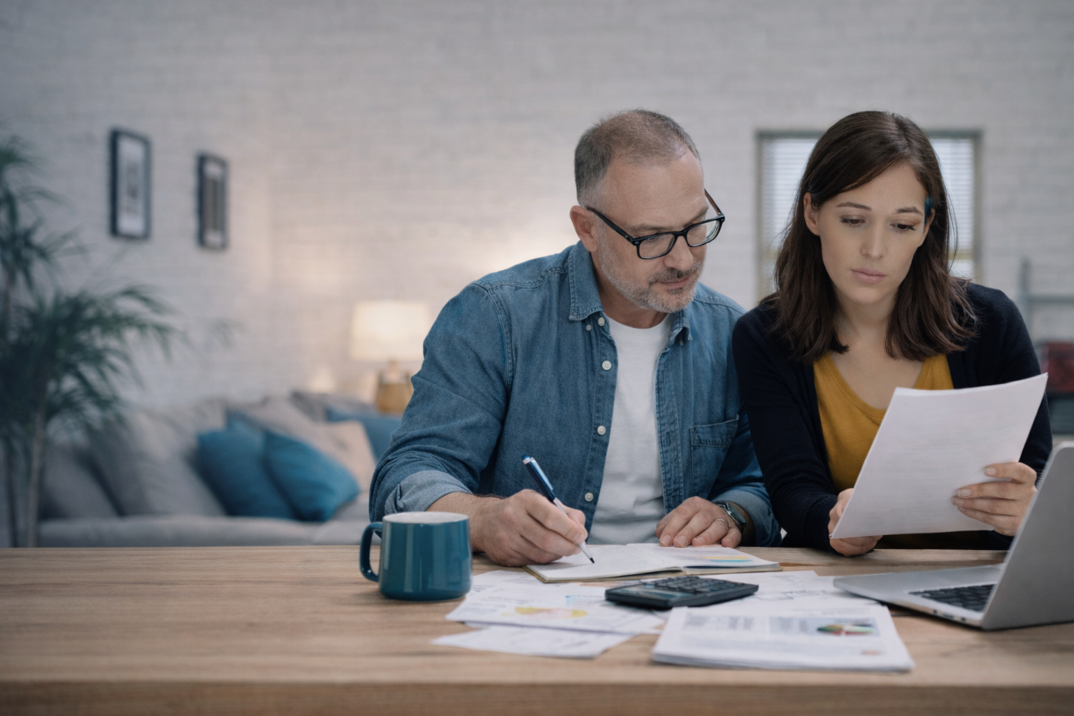 Self employed individuals reviewing accounts and tax documents at home