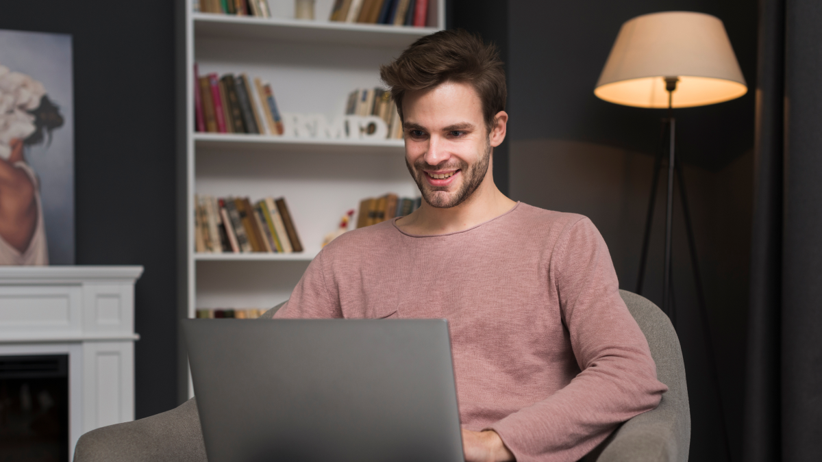 A business owner using a laptop at home while managing digital bookkeeping and Making Tax Digital software.