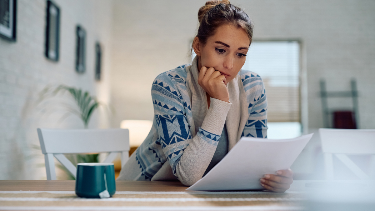Individual reviewing tax documents at home while preparing records for their next Self Assessment tax return.